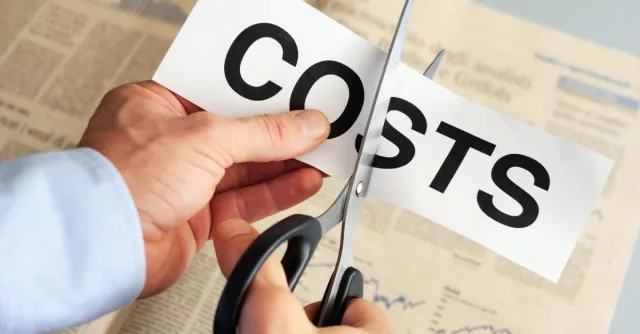 man cutting the word costs