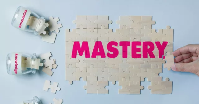 The word mastery being formed with puzzle pieces stating knowledge and wisdom