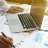 Man works with reports and laptop, RecoveryPlanner