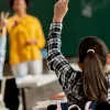 A child raises their hand